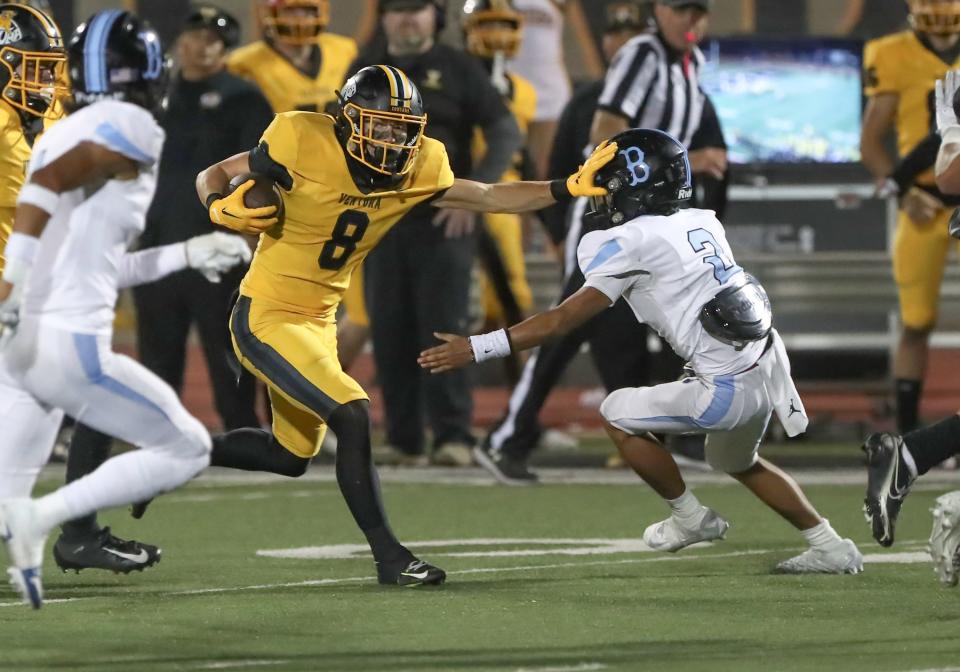 Ventura's Mylan Walker stiff-arms Buena's Erick Guzman during the teams' rivalry game on Oct. 13.