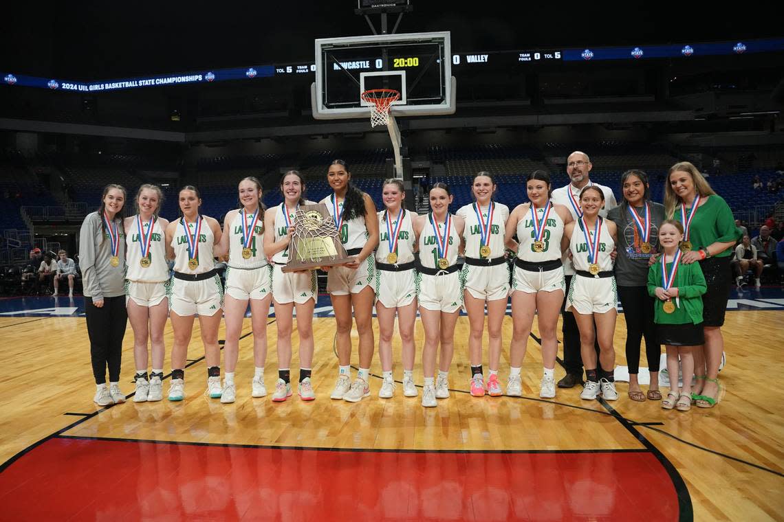 The Newcastle Ladycats pose with their hardware after winning the Class 1A state championship game on Saturday, March 2, 2024 at the Alamodome in San Antonio, Texas. Newcastle defeated Turkey Valley 48-32.