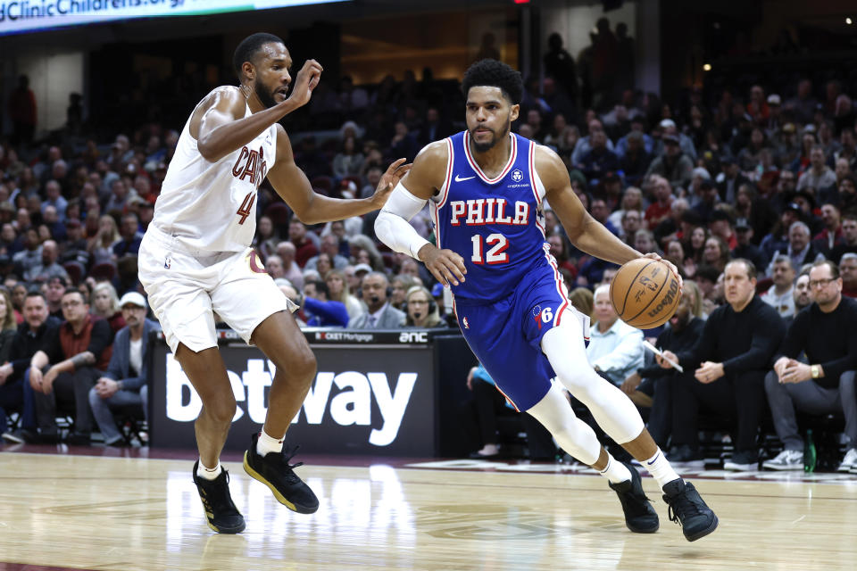 Philadelphia 76ers forward Tobias Harris (12) drives against Cleveland Cavaliers forward Evan Mobley (4) during the first half of an NBA basketball game Friday, March 29, 2024, in Cleveland. (AP Photo/Ron Schwane)
