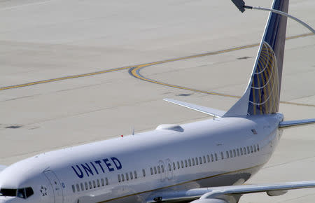 A United Airlines plane with the Continental Airlines logo on its tail, sits at a gate at O'Hare International airport in Chicago October 1, 2010. REUTERS/Frank Polich/File Photo