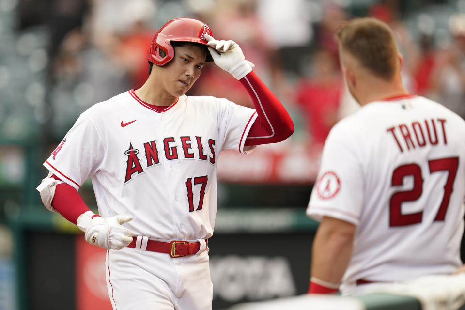 Los Angeles Angels designated hitter Shohei Ohtani (17) is greeted by Mike Trout (27) after hitting a home run during the seventh inning of a baseball game against the Detroit Tigers in Anaheim, Calif., Wednesday, Sept. 7, 2022. (AP Photo/Ashley Landis)