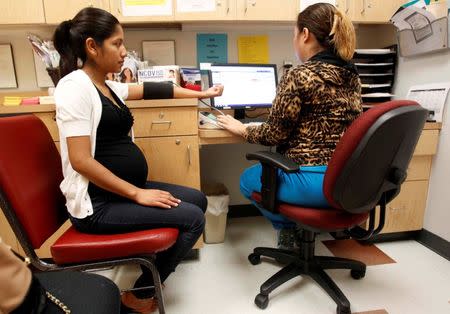 Expectant mother Nadia Reyna gets her blood pressure checked by medical assistant Gaby Gonzalez at Nuestra Clinica de Valle women's clinic in San Juan, Texas, September 22, 2015. REUTERS/Delcia Lopez