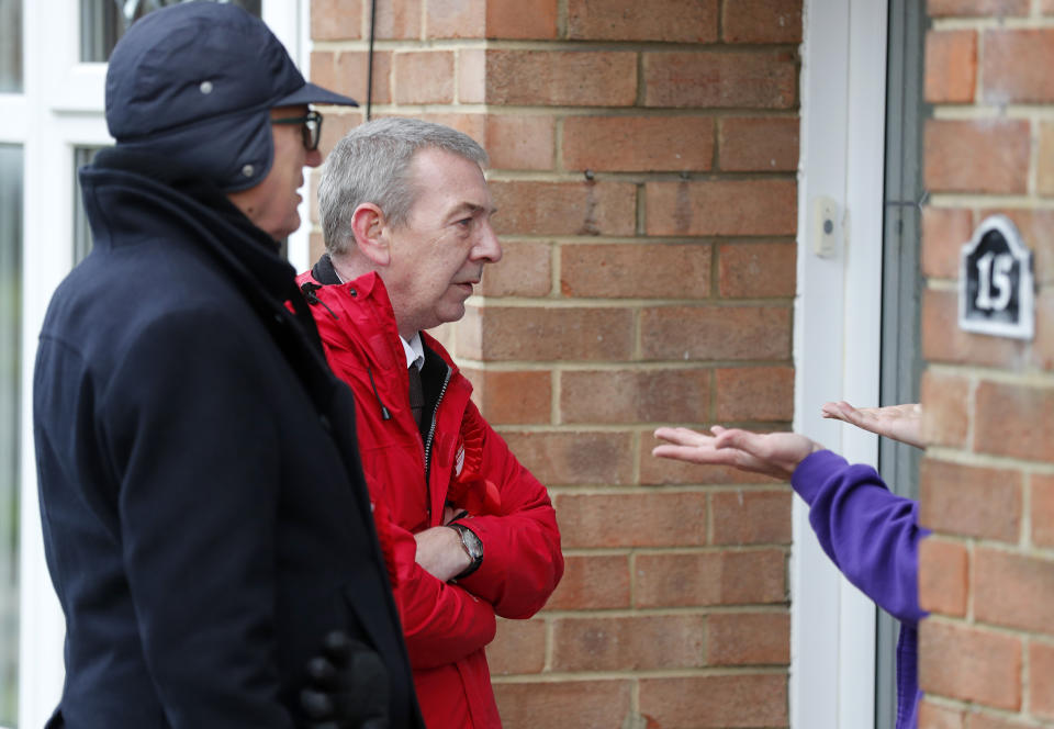 Labour candidate for Hartlepool Mike Hill, center, speaks to residents as he campaigns in residential areas in Hartlepool, England, Monday, Nov. 11, 2019. Hartlepool has elected lawmakers from the left-of-center Labour Party for more than half a century. But in 2016, almost 70% of voters here backed leaving the European Union. (AP Photo/Frank Augstein)