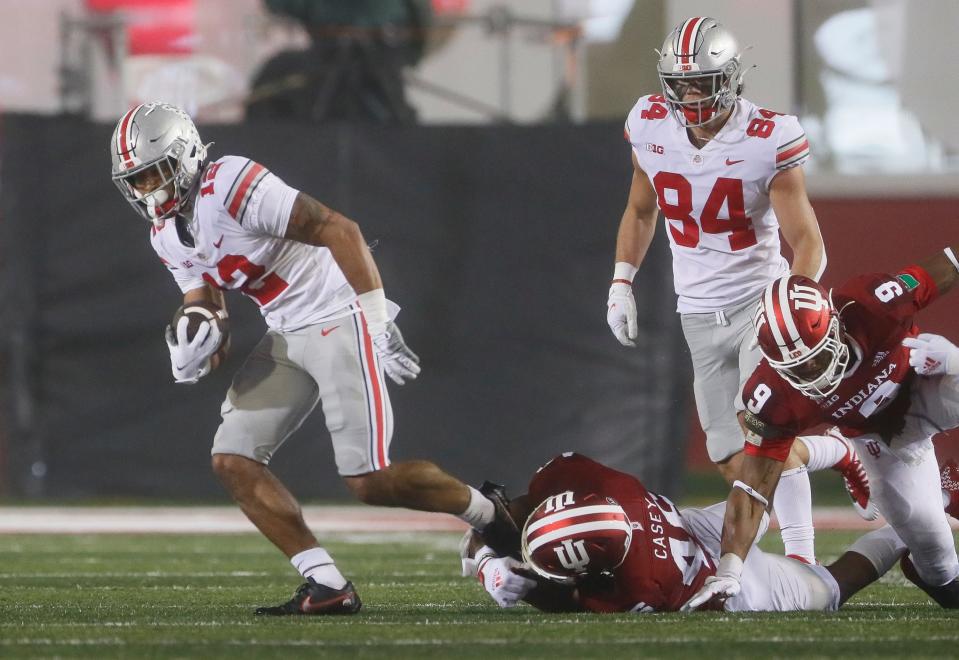 Ohio State Buckeyes wide receiver Emeka Egbuka (12) breaks a tackle attempt by Indiana Hoosiers linebacker Aaron Casey (46) during the fourth quarter of the NCAA football game at Memorial Stadium in Bloomington, Ind. on Saturday, Oct. 23, 2021. Ohio State won 54-7. Credit: Adam Cairns/Columbus Dispatch-USA TODAY NETWORK