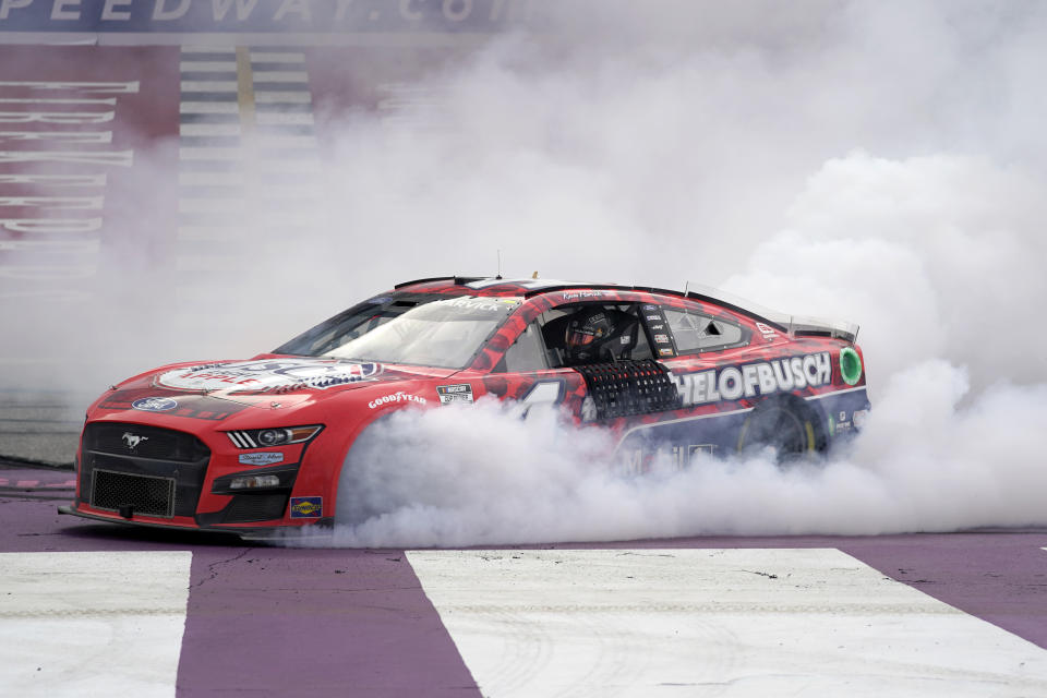 Kevin Harvick celebrates with a burnout after winning the NASCAR Cup Series auto race at the Michigan International Speedway in Brooklyn, Mich., Sunday, Aug. 7, 2022. (AP Photo/Paul Sancya)