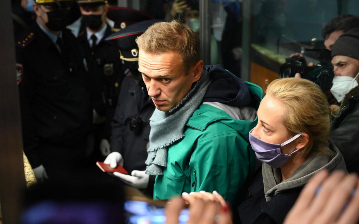 Russian opposition leader Alexei Navalny and his wife Yulia arrive in Moscow - KIRILL KUDRYAVTSEV/AFP via Getty Images