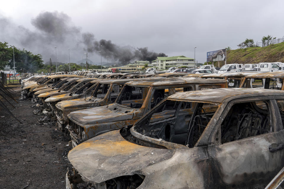 Burnt cars are lined up after unrest in Noumea, New Caledonia, Wednesday May 15, 2024. France has imposed a state of emergency in the French Pacific territory of New Caledonia. The measures imposed on Wednesday for at least 12 days boost security forces' powers to quell deadly unrest that has left four people dead, erupting after protests over voting reforms. (AP Photo/Nicolas Job)