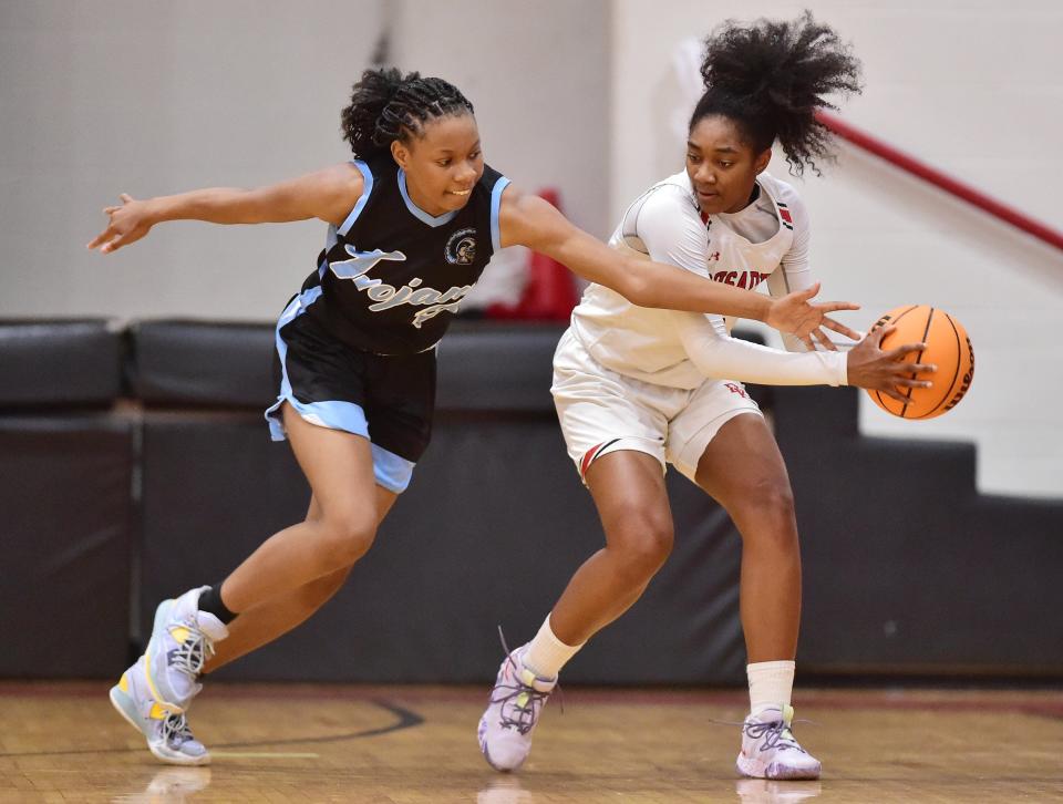 Bishop Kenny forward Sydney Roundtree (right) tries to hold the basketball against pressure during a February game against Ribault.