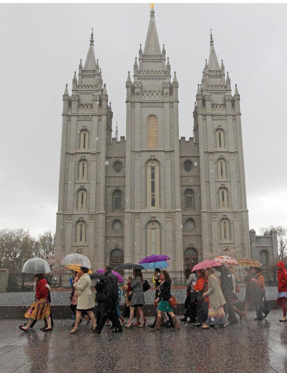 A Mormon's women group pushing the church to allow women in the priesthood march to Temple Square during the two-day Mormon church conference Saturday, April 5, 2014, in Salt lake City. The church has asked them to reconsider, and barred media from going on church property during the demonstration. Mormon officials allowed the women's group to demonstrate its displeasure for not being allowed in an all-male meeting, on church property but still didn't let them attend. (AP Photo/Rick Bowmer)