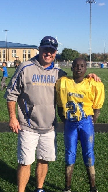 Ontario eighth-grade football coach Alan Miller (left) coached his son Bodpegn in middle school football.