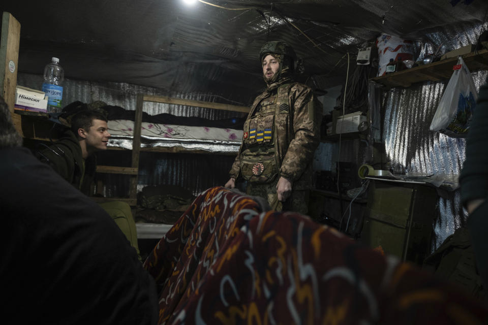 Ukrainian soldiers chat in a shelter in position on the front-line near Klishchiivka, Donetsk region, Ukraine, Monday, March 18, 2024. (Iryna Rybakova via AP)