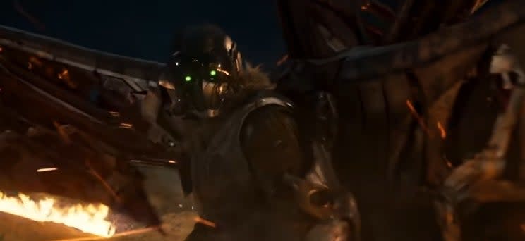 Vulture standing in front of a flaming plane crash site in "Spider-Man: Homecoming"