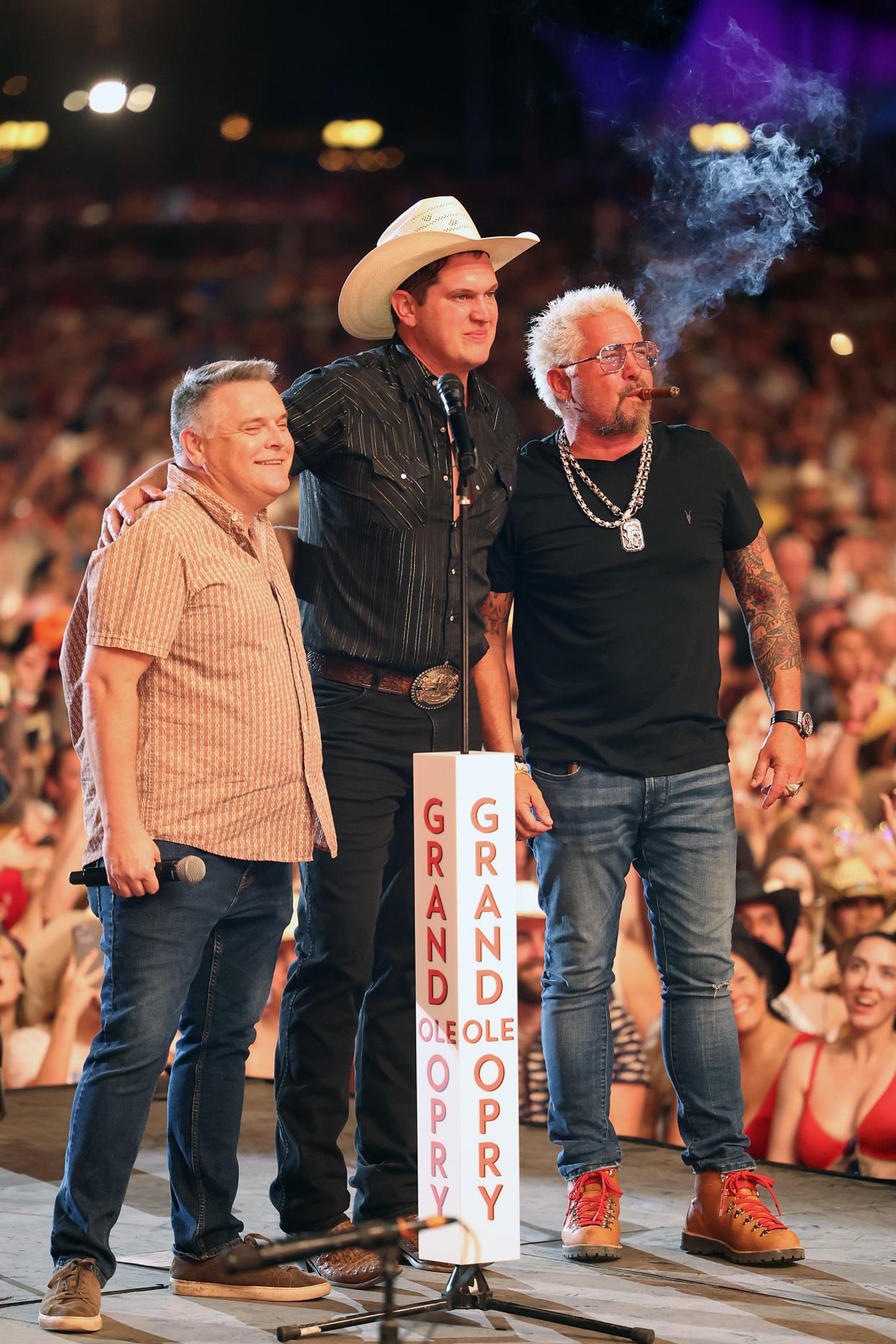 Grand Ole Opry VP and Executive Producer Dan Rogers, Jon Pardi, and Guy Fieri pose onstage during Day 1 of the 2023 Stagecoach Festival on April 28, 2023 in Indio, California.