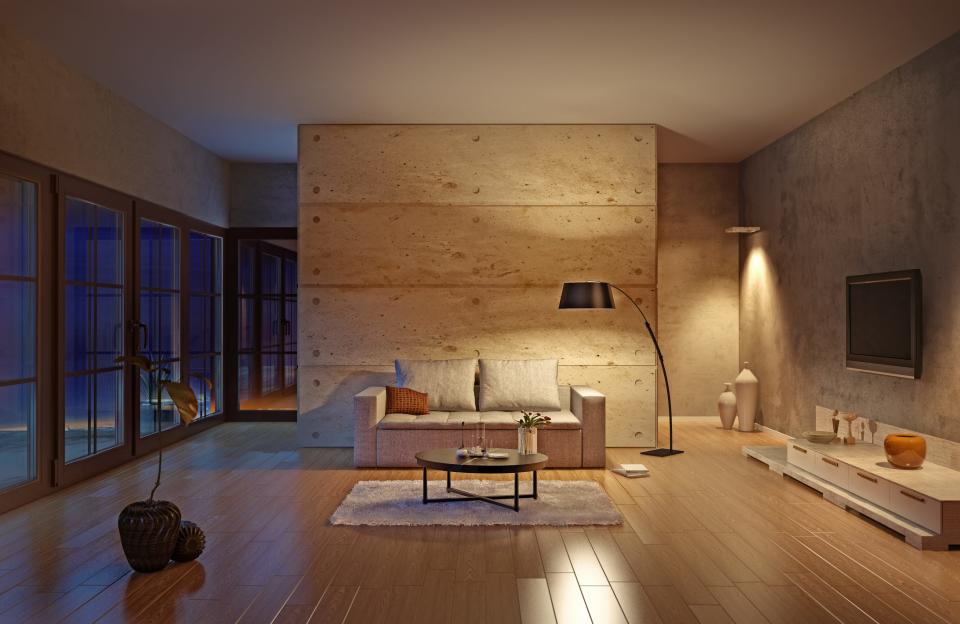 living room with small couch, lights shining on furniture and wall