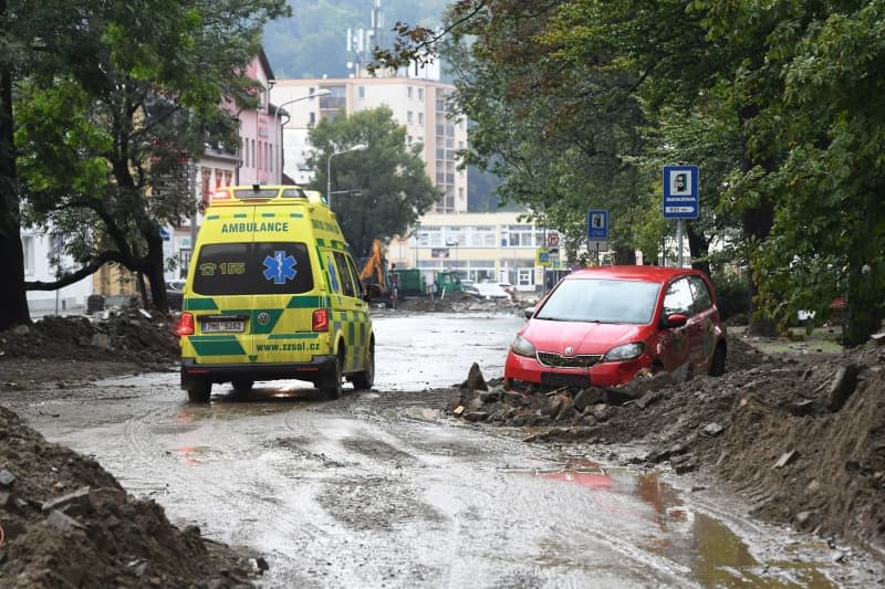 An ambulance drives through the streets in the centre of the town after the heavy rainfall. Peøina Ludìk/CTK/dpa