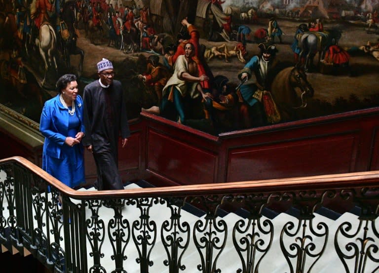 Patricia Scotland (L), secretary-general of the Commonwealth, speaks with Nigerian President Muhammadu Buhari on arrival at the corruption conference in London on May 11, 2016