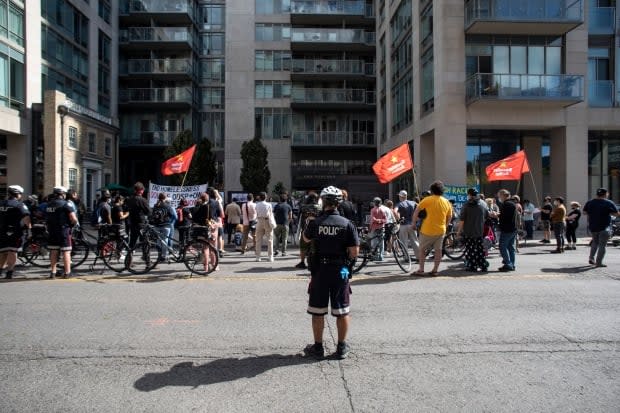 People experiencing homelessness and their supporters gathered outside the home of Toronto Mayor John Tory on Thursday. (The Canadian Press - image credit)