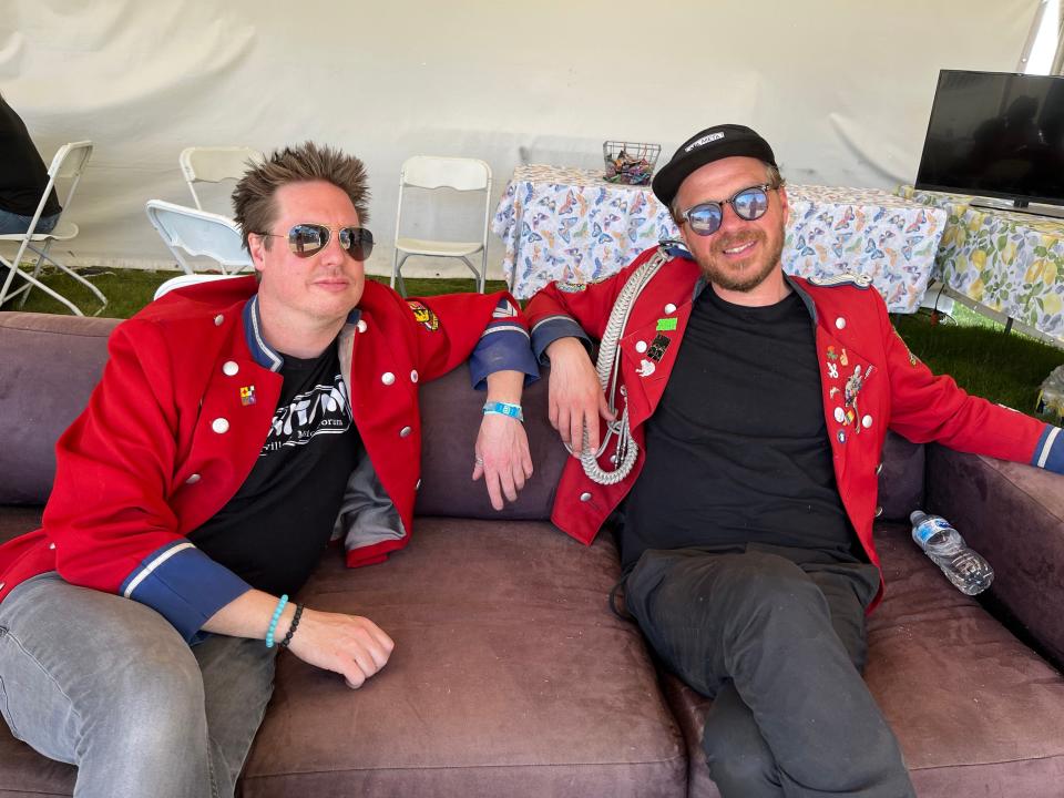 Trombonist Johnny Johnson and trumpeter Thomas Burhorn of Meute relax after their performance at the Coachella Valley Music and Arts Festival in Indio, Calif., on April 22, 2022.