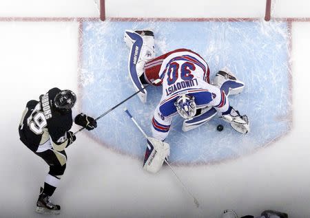 May 9, 2014; Pittsburgh, PA, USA; New York Rangers goalie Henrik Lundqvist (30) makes a save as Pittsburgh Penguins center Brian Gibbons (49) looks for a rebound during the first period in game five of the second round of the 2014 Stanley Cup Playoffs at the CONSOL Energy Center. The Rangers won 5-1. Mandatory Credit: Charles LeClaire-USA TODAY Sports