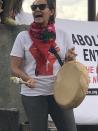 A protester celebrates the removal of a statue of Spanish colonial ruler Juan de Onate, in Alcalde, New Mexico