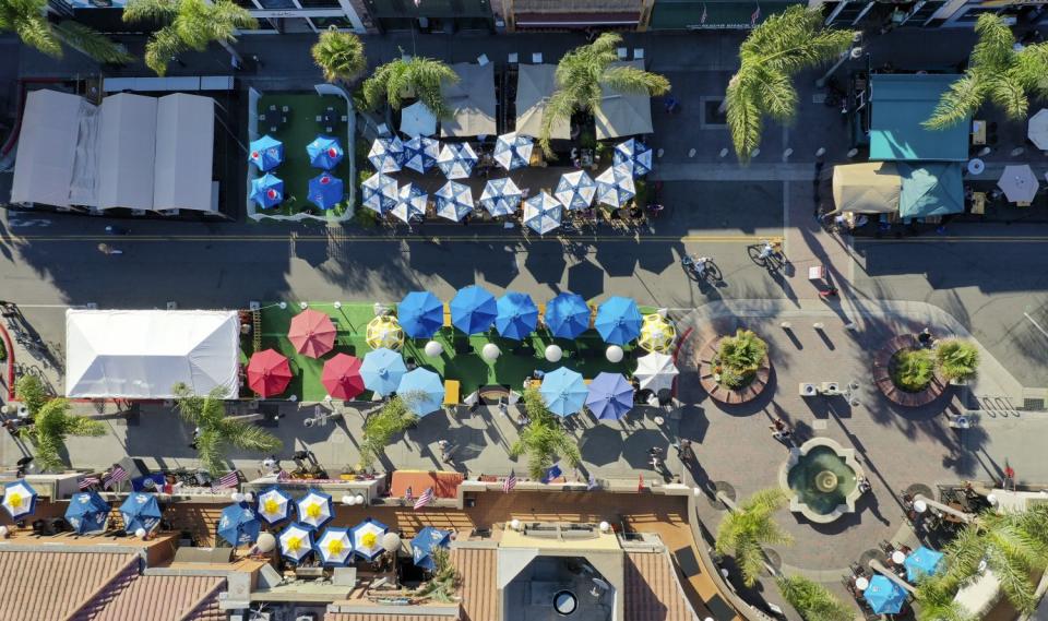 An aerial view of outdoor dining as restaurants moved onto Main Street in Huntington Beach.