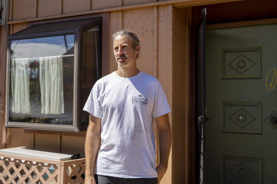 Daniel Skousen poses for a portrait in front of his home on Friday, Nov. 3, 2023, in Lahaina, Hawaii. (AP Photo/Mengshin Lin)