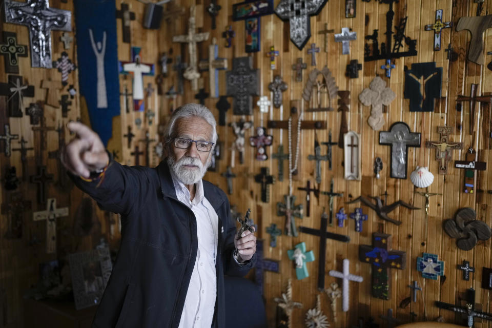 Jesuit Priest Javier Avila gives an interview in his office decorated with crosses and crucifixes in Creel, Mexico, Monday, May 13, 2024. Often, people knock on his door, asking for a marriage, a divorce or a blessing. Others seek help to find missing family members or to denounce excessive use of force by the National Guard.“People still believe in us,” said Ávila, who has worked in the region since the 1970s. (AP Photo/Eduardo Verdugo)