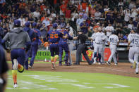 Both dugouts empty and umpires try to keep order after Seattle Mariners batter Ty France was hit by a pitch from Houston Astros relief pitcher Hector Neris during the ninth inning of a baseball game Monday, June 6, 2022, in Houston. (AP Photo/Michael Wyke)