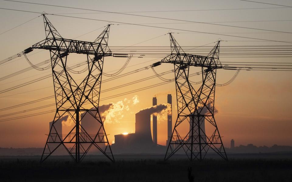 Power lines near Eskom's Lethabo coal fired power station as the sun rises, near Johannesburg - KIM LUDBROOK/EPA-EFE/Shutterstock