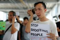 People use mobile phones to listen to a news conference, as they gather to wait for a government announcement regarding the proposed extradition bill, near the Legislative Council building in Hong Kong