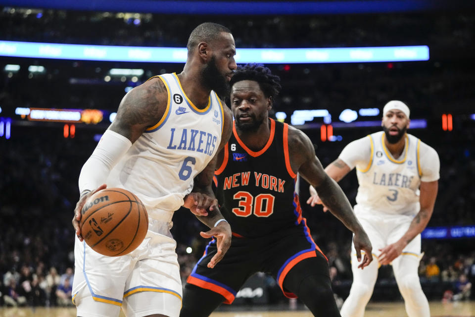 Los Angeles Lakers' LeBron James (6) drives past New York Knicks' Julius Randle (30) during the second half of an NBA basketball game Tuesday, Jan. 31, 2023, in New York. The Lakers won 129-123 in overtime. (AP Photo/Frank Franklin II)