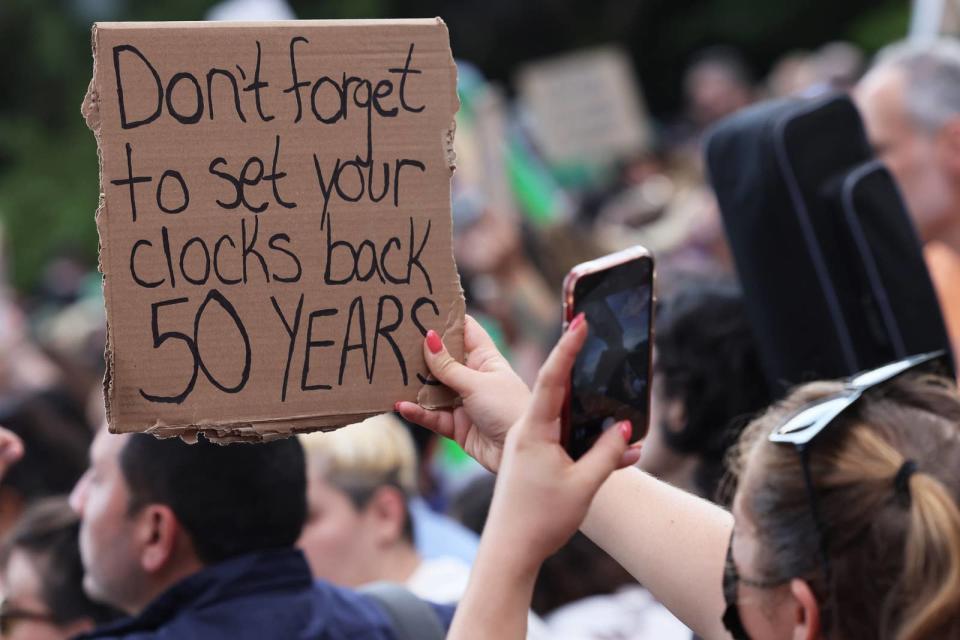 Sign held up: "Don't forget to set your clocks back 50 years"