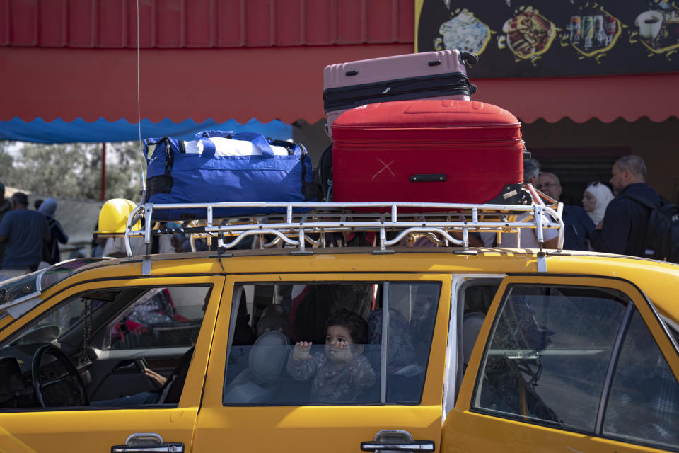 Palestinians wait to cross into Egypt at the Rafah border crossing in the Gaza Strip on Monday, Oct.16, 2023. (AP Photo/Fatima Shbair)