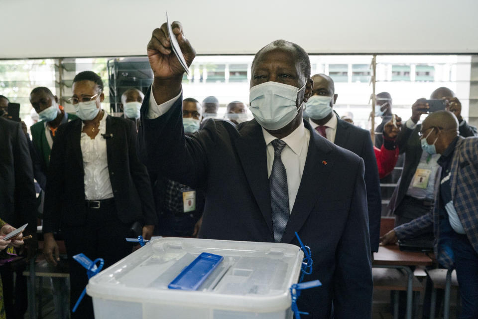 Ivory Coast President Alassane Ouattara casts his vote at a polling station during presidential elections in Abidjan, Ivory Coast, Saturday, Oct. 31, 2020. Tens of thousands of security forces deployed across Ivory Coast on Saturday as the leading opposition parties boycotted the election, calling President Ouattara's bid for a third term illegal. (AP Photo/Leo Correa)