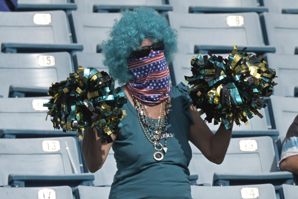 A Jacksonville Jaguars fan cheers during the first half of an NFL football game against the Cleveland Browns, Sunday, Nov. 29, 2020, in Jacksonville, Fla. (AP Photo/Phelan M. Ebenhack)