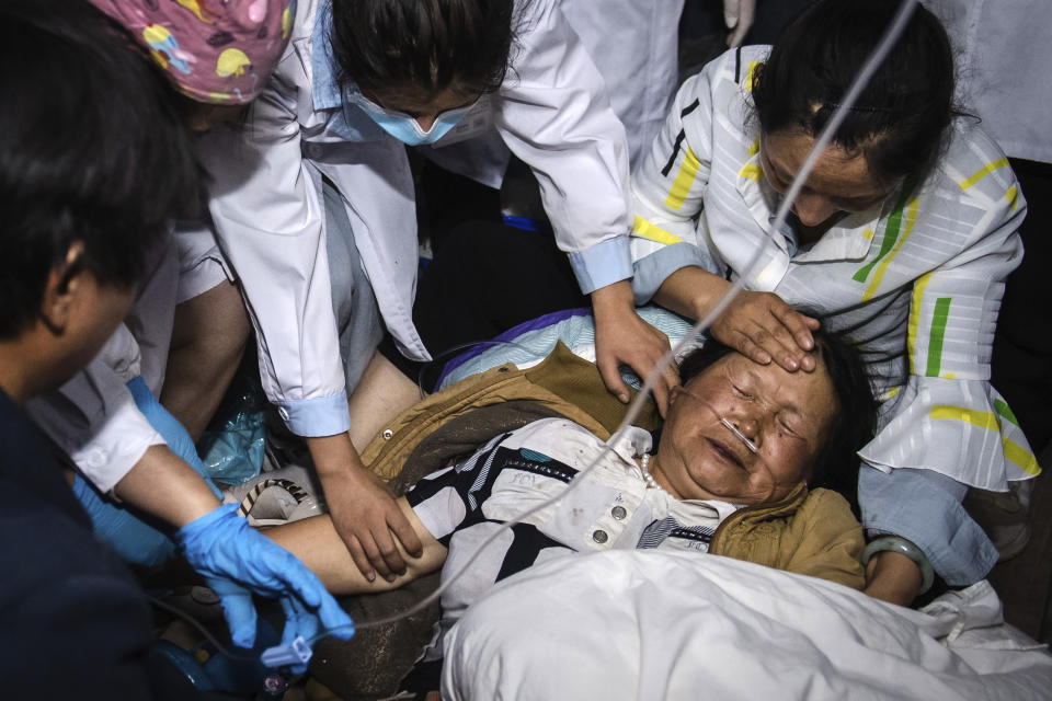 In this photo released by China's Xinhua News Agency, medical workers treat a woman after an earthquake in Yangbi Yi Autonomous County in southwestern China's Yunnan Province, early Saturday, May 22, 2021. A pair of strong earthquakes struck two provinces in China overnight on Saturday. (Hu Chao/Xinhua via AP)