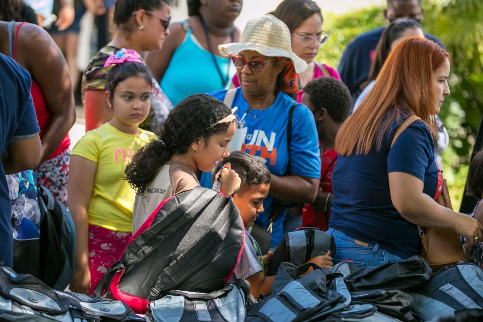 Students and their families pick out backpacks Saturday during the Stop the Violence Back to School Rally at Santa Fe College in Gainesville.