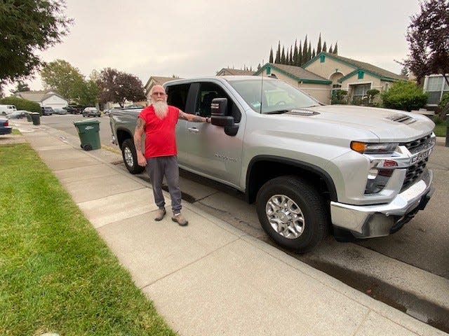 Douglas Settell stands of Sacramento, California stands by the 2020 Chevrolet Silverado heavy-duty pickup he traded for his 2018 Chevrolet Corvette Grand Sport after the sports car had two cracked wheel rims. October 8, 2020.