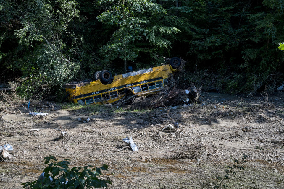 Image: A Perry County school bus is flipped over in River Caney Creek in Breathitt County, Ky. on Aug. 3, 2022. (Michael Swensen for NBC News)