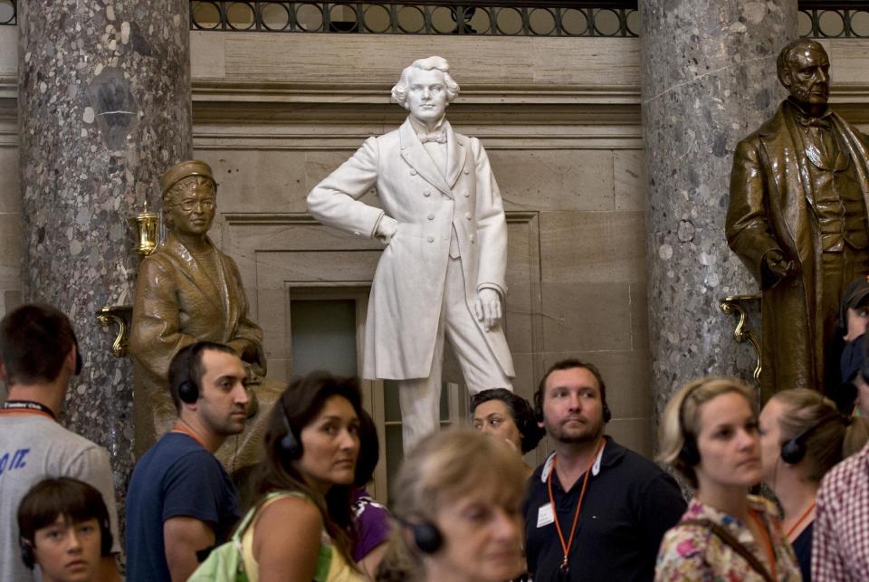 A statue of John Gorrie of Florida, center, inventor of the ice machine, stands next to the popular Rosa Parks, left, in Statuary Hall at the Capitol in Washington, Tuesday, July 2, 2013. A physician, scientist, and inventor, Gorrie is considered the father of refrigeration and air-conditioning; he died impoverished and virtually forgotten in 1855. Among the U.S. Capitol’s many statues which honor the nation’s founders, leaders and legends, the marble figure by scuptor C.A. Pillars, is largely overlooked by thousands of visitors who tour the Capitol daily. At right is Samuel Kirkwood who became famous as the governor of Iowa during the Civil War. (AP Photo/J. Scott Applewhite)