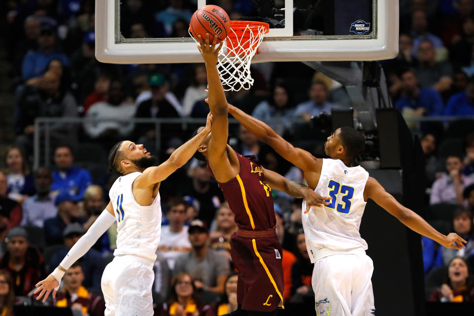 <p>Aundre Jackson #24 of the Loyola Ramblers shoots in the second half against Cody Martin #11 and Josh Hall #33 of the Nevada Wolf Pack during the 2018 NCAA Men’s Basketball Tournament South Regional at Philips Arena on March 22, 2018 in Atlanta, Georgia. (Photo by Kevin C. Cox/Getty Images) </p>
