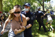 Protesters scuffle with police as they are arrested when a small group marched through Hyde Park following an Invasion Day rally in Sydney, Tuesday, Jan. 26, 2021. Many of Australia's First Nations people say that sovereignty has never been ceded and oppose ongoing colonial violence and destruction. (Dean Lewins/AAP Image via AP)