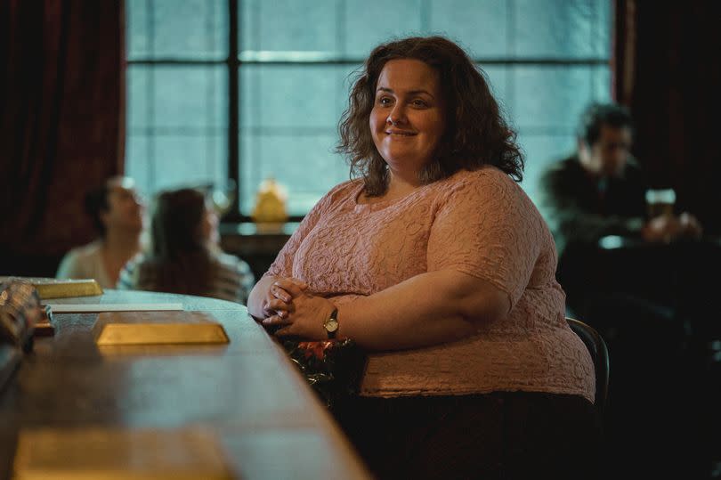 A woman sat at a bar, staring lovingly off into the distance