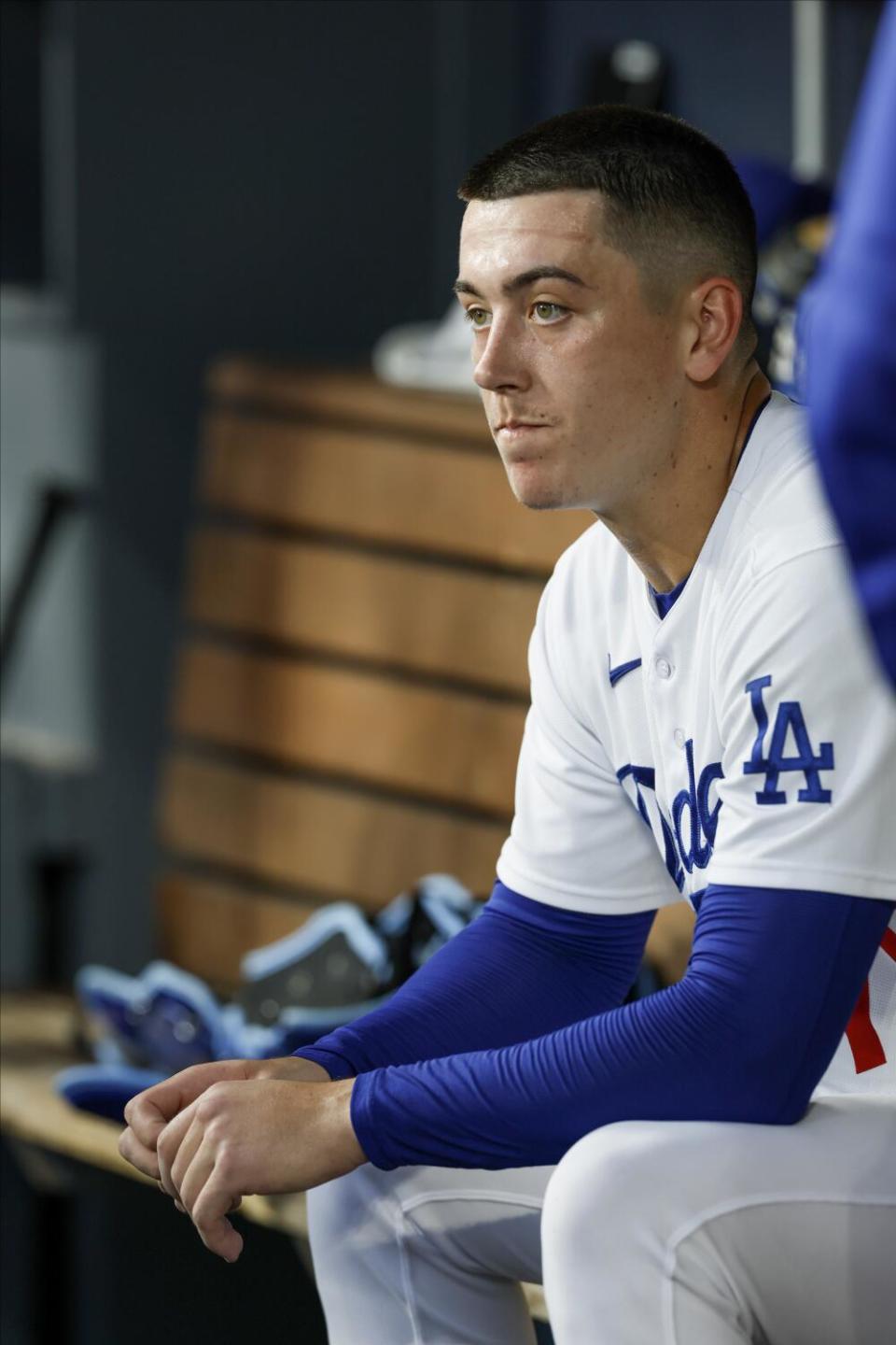 Bobby Miller sits in the dugout.