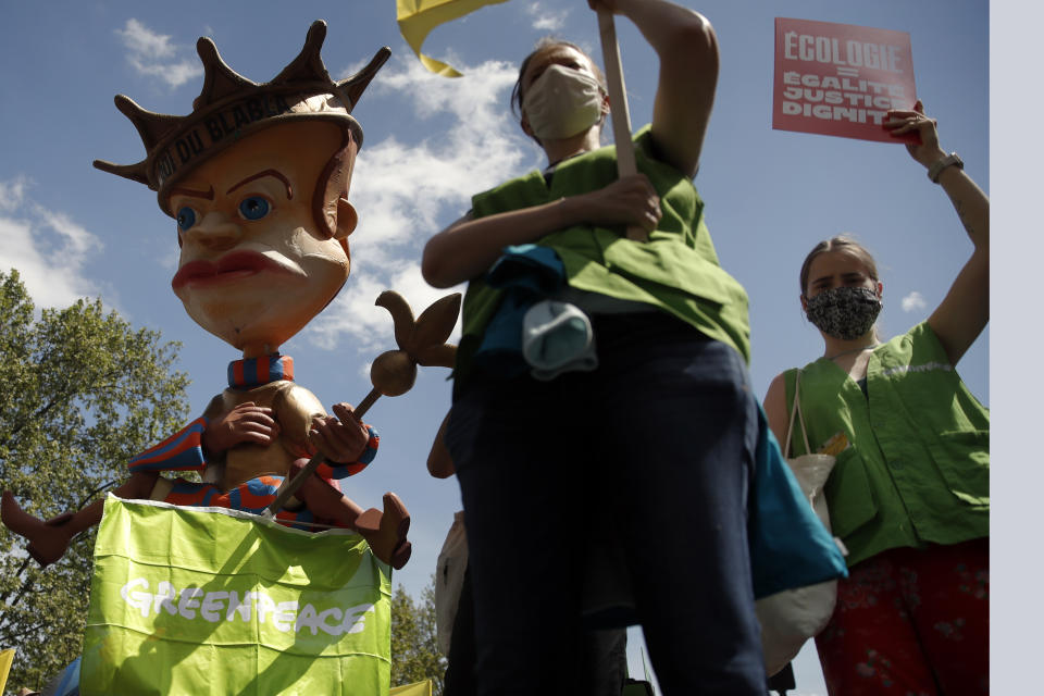 Demonstrators attend a rally against the climate change in Paris, Sunday, May 9, 2021. Thousands of French demonstrators took to the streets of Paris and other cities on Sunday to call for more ambitious measures to fight against climate change. (AP Photo/Christophe Ena)