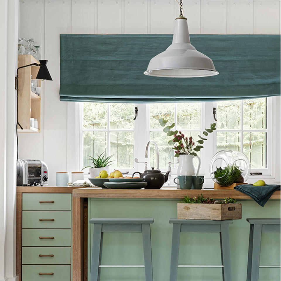 kitchen with white wall window white lamp and wooden counter