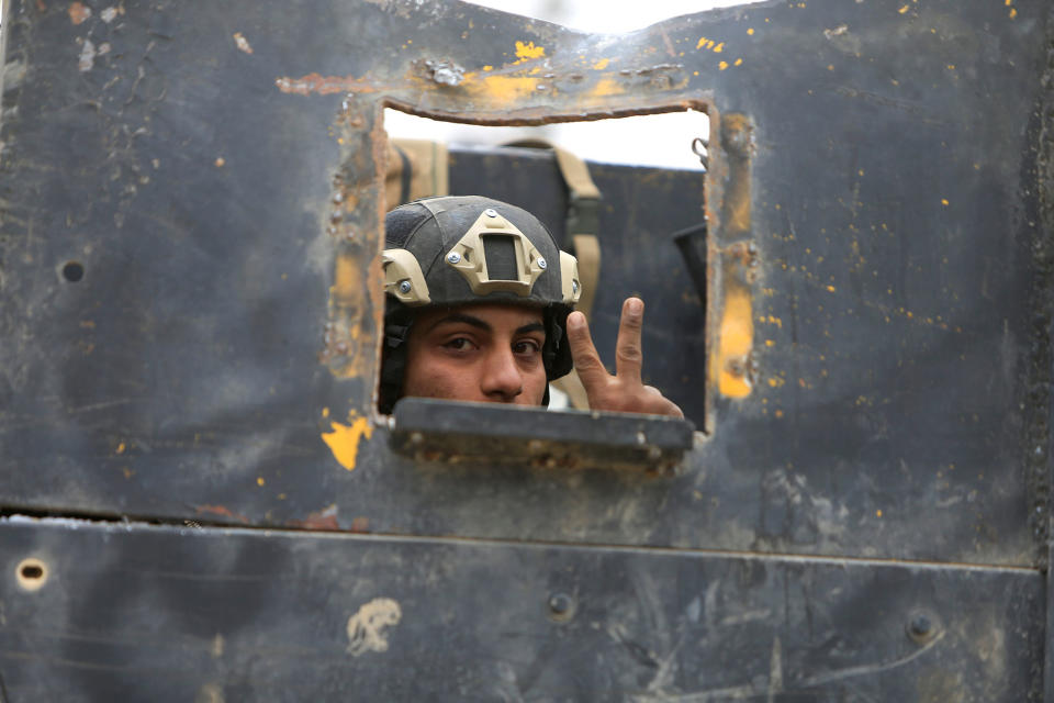 Iraqi Special Operations Forces soldier gestures in Mosul