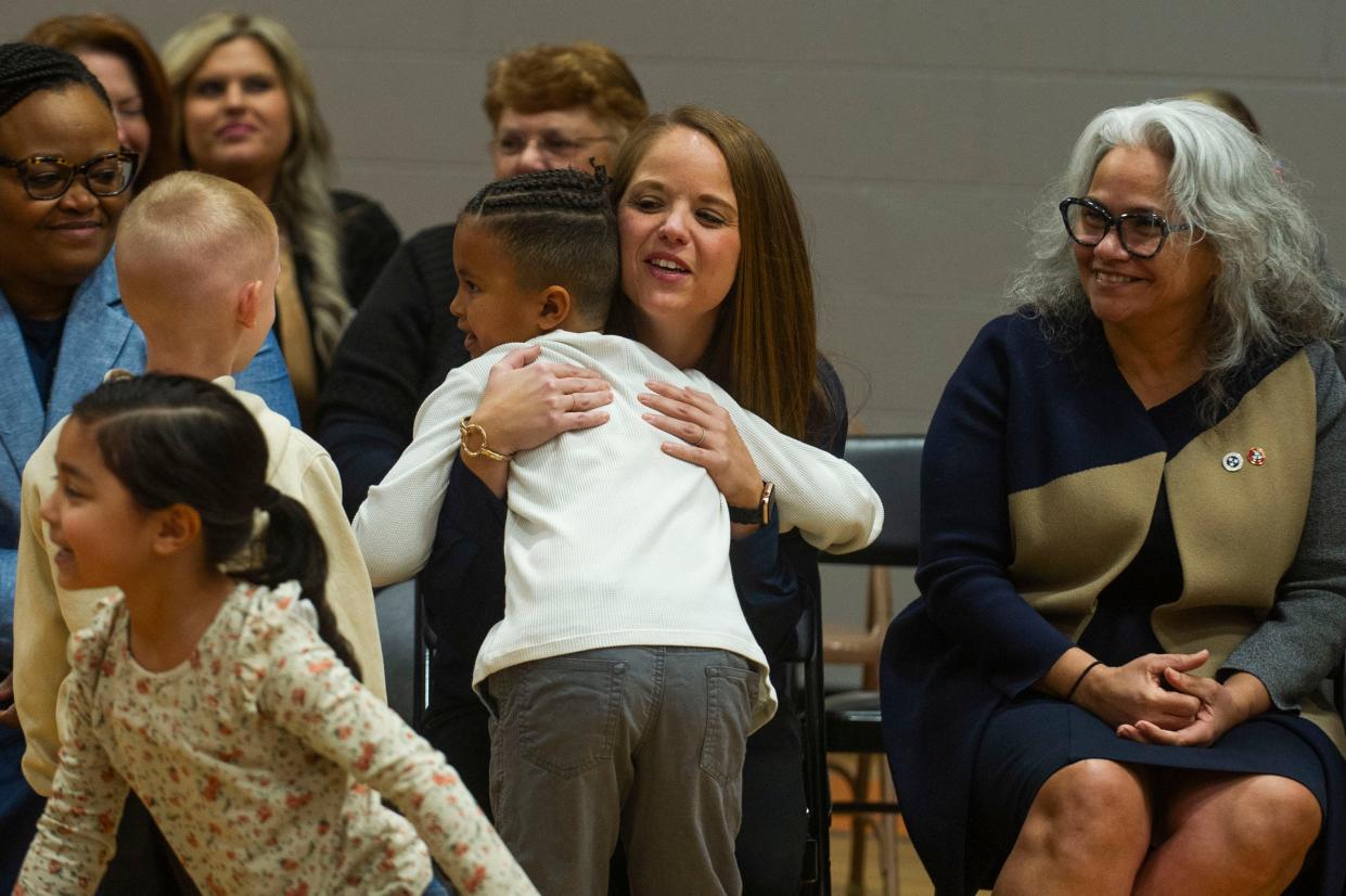 Tennessee Education Commissioner Lizzette Reynolds, right, sits next to Clinton Elementary School Assistant Principal Abbey Cox Kidwell, who was being hugged by a student on March 28. Kidwell was awarded the Milken Education Award and $25,000 from the Milken Family Foundation.