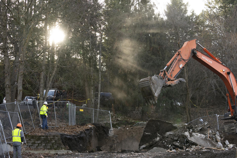 FILE - Sunlight breaks through trees as heavy equipment works to demolish the final pieces of the foundation of the house where four University of Idaho students were killed in 2022 on Thursday, Dec. 28, 2023, in Moscow, Idaho. Students Ethan Chapin, Xana Kernodle, Madison Mogen and Kaylee Goncalves were fatally stabbed there in November 2022. Attorneys for Bryan Kohberger, the man charged with stabbing four University of Idaho students to death, are expected to ask a judge to move the trial away from the rural college town where the slayings occurred. (AP Photo/Ted S. Warren, File)