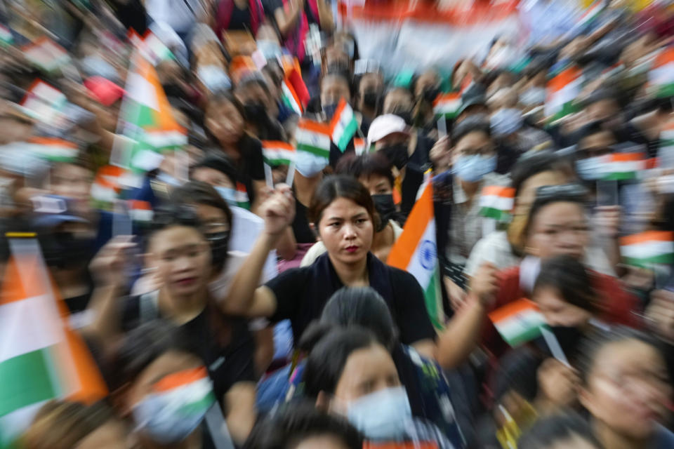 Members of the Kuki tribe protesting against the killing of tribals in their northeastern home state of Manipur, hold Indian flags during a sit in protest in New Delhi, India, Monday, May 29, 2023. Manipur, which borders Myanmar, has been roiled by violence since 3 May after members of tribal groups clashed with a non-tribal group over demands of economic benefits and reservation status. More shootings and arson were reported Monday from the northeastern state, where dozens have been killed and more than 35,000 displaced following the worst ethnic clashes seen in decades. (AP Photo/Manish Swarup)